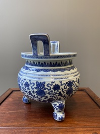 A large Chinese blue and white 'bajixiang' and 'lotus scrolls' tripod censer, Qianlong
