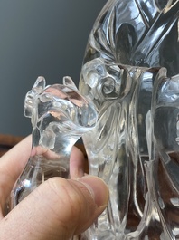 A Chinese rock crystal sculpture of Lan Caihe on wooden stand, 19th C.