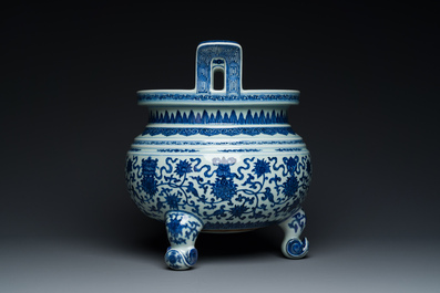A large Chinese blue and white 'bajixiang' and 'lotus scrolls' tripod censer, Qianlong