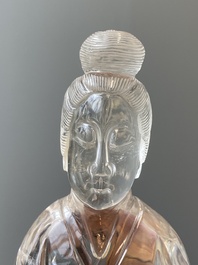 A Chinese rock crystal sculpture of Lan Caihe on wooden stand, 19th C.