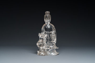 A Chinese rock crystal sculpture of Lan Caihe on wooden stand, 19th C.