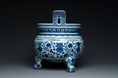 A large Chinese blue and white 'bajixiang' and 'lotus scrolls' tripod censer, Qianlong