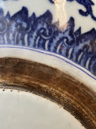 A large Chinese blue and white 'bajixiang' and 'lotus scrolls' tripod censer, Qianlong
