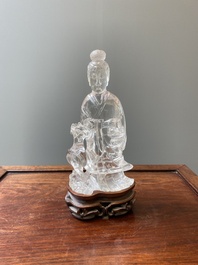 A Chinese rock crystal sculpture of Lan Caihe on wooden stand, 19th C.