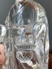 A Chinese rock crystal sculpture of Lan Caihe on wooden stand, 19th C.