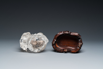 A Chinese rock crystal sculpture of Lan Caihe on wooden stand, 19th C.