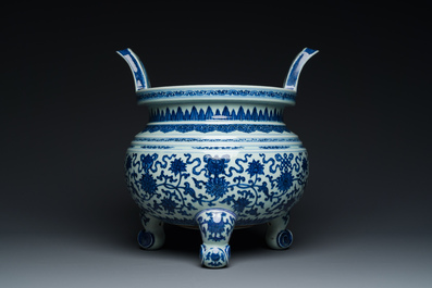 A large Chinese blue and white 'bajixiang' and 'lotus scrolls' tripod censer, Qianlong
