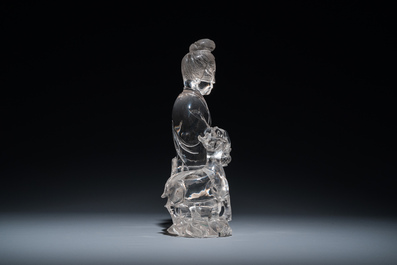 A Chinese rock crystal sculpture of Lan Caihe on wooden stand, 19th C.