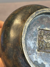A small Chinese bronze bottle vase with lion-form handles, Qing, 17th C.