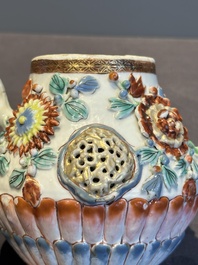 A Chinese famille rose teapot and stand with floral relief design, Qianlong