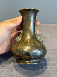A small Chinese bronze bottle vase with lion-form handles, Qing, 17th C.