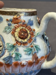 A Chinese famille rose teapot and stand with floral relief design, Qianlong