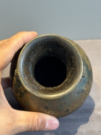 A small Chinese bronze bottle vase with lion-form handles, Qing, 17th C.