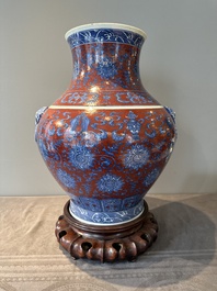A Chinese blue, white and iron-red 'bajixiang' 'hu' vase on wooden stand, Qianlong mark, 19th C.
