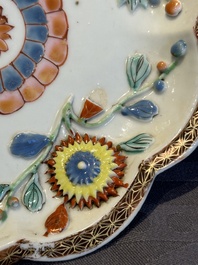 A Chinese famille rose teapot and stand with floral relief design, Qianlong