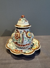 A Chinese famille rose teapot and stand with floral relief design, Qianlong