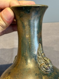 A small Chinese bronze bottle vase with lion-form handles, Qing, 17th C.