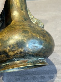 A small Chinese bronze bottle vase with lion-form handles, Qing, 17th C.