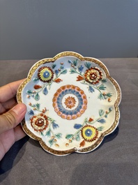 A Chinese famille rose teapot and stand with floral relief design, Qianlong