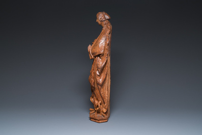 A Flemish late gothic carved oak sculpture of Saint Thecla on a pyre, Brabant region, first half 16th C.