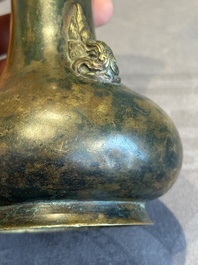 A small Chinese bronze bottle vase with lion-form handles, Qing, 17th C.