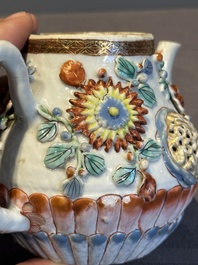 A Chinese famille rose teapot and stand with floral relief design, Qianlong
