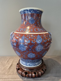 A Chinese blue, white and iron-red 'bajixiang' 'hu' vase on wooden stand, Qianlong mark, 19th C.