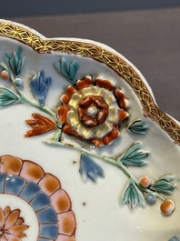 A Chinese famille rose teapot and stand with floral relief design, Qianlong