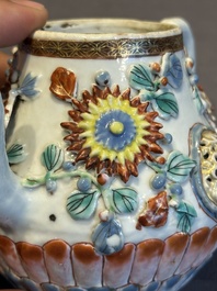 A Chinese famille rose teapot and stand with floral relief design, Qianlong