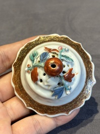 A Chinese famille rose teapot and stand with floral relief design, Qianlong