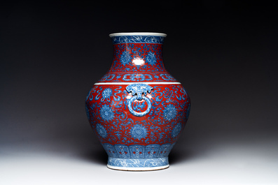 A Chinese blue, white and iron-red 'bajixiang' 'hu' vase on wooden stand, Qianlong mark, 19th C.