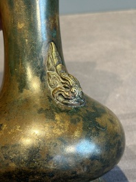 A small Chinese bronze bottle vase with lion-form handles, Qing, 17th C.