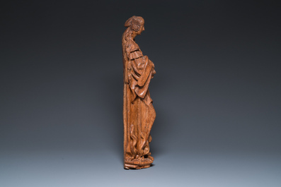 A Flemish late gothic carved oak sculpture of Saint Thecla on a pyre, Brabant region, first half 16th C.
