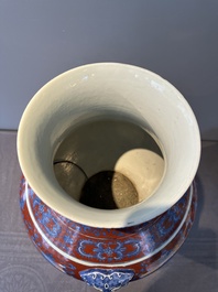 A Chinese blue, white and iron-red 'bajixiang' 'hu' vase on wooden stand, Qianlong mark, 19th C.