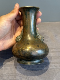 A small Chinese bronze bottle vase with lion-form handles, Qing, 17th C.