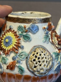 A Chinese famille rose teapot and stand with floral relief design, Qianlong
