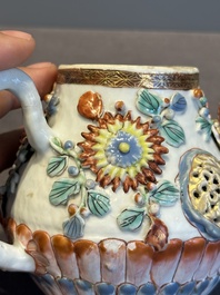 A Chinese famille rose teapot and stand with floral relief design, Qianlong