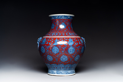 A Chinese blue, white and iron-red 'bajixiang' 'hu' vase on wooden stand, Qianlong mark, 19th C.