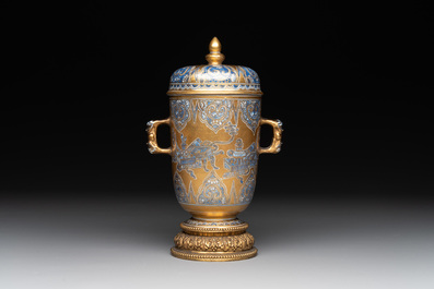 A Chinese gilt-ground blue and white lidded beaker on a French gilt bronze foot, Kangxi
