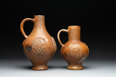 Two armorial stoneware jugs, Raeren, one dated 1586, 16/17th C.