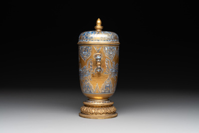 A Chinese gilt-ground blue and white lidded beaker on a French gilt bronze foot, Kangxi