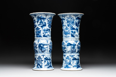 Two Chinese blue and white 'gu' vases with landscape and floral panels, Kangxi