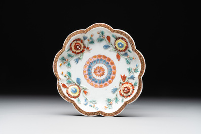A Chinese famille rose teapot and stand with floral relief design, Qianlong