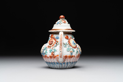 A Chinese famille rose teapot and stand with floral relief design, Qianlong