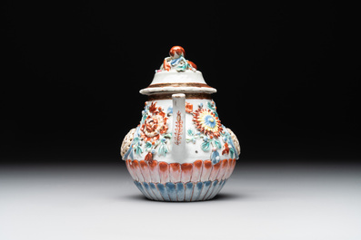 A Chinese famille rose teapot and stand with floral relief design, Qianlong