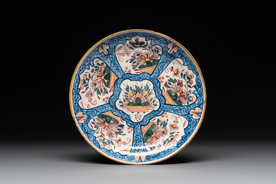 Seven Dutch Delft polychrome 'flower basket' plates, 18th C.