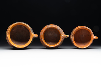 A collection of 10 parcel-glazed pottery so-called &lsquo;grapen&rsquo;, tripod cooking pots, 14th/17th C.