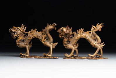 A pair of Chinese gilt bronze dragons among flames and clouds, 19/20th C.