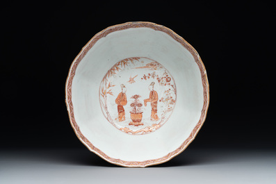 A Chinese iron-red and gilt-decorated 'ladies in a garden' bowl, Kangxi