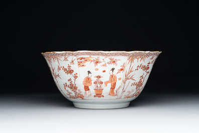 A Chinese iron-red and gilt-decorated 'ladies in a garden' bowl, Kangxi